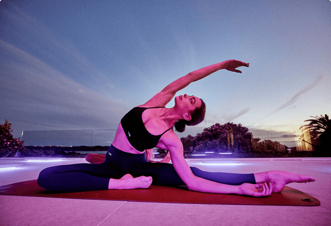 Woman stretching on yoga mat